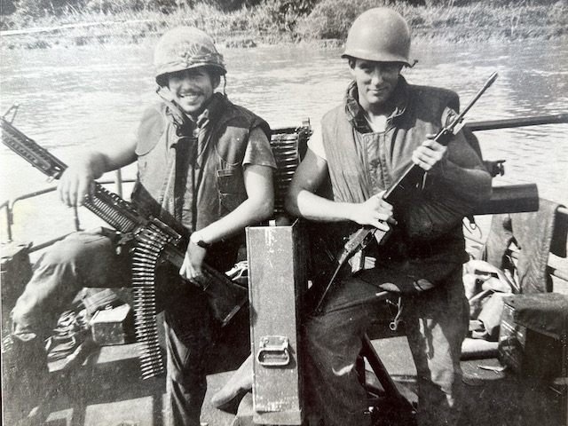 Elmo R. Zumwalt, III, alongside Whiting Shuford, a crew member on a swift boat during the Vietnam War.
