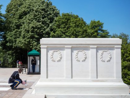A soldier from the 3rd US Infantry Regiment, the "Old Guard", places a US flag at the Tomb