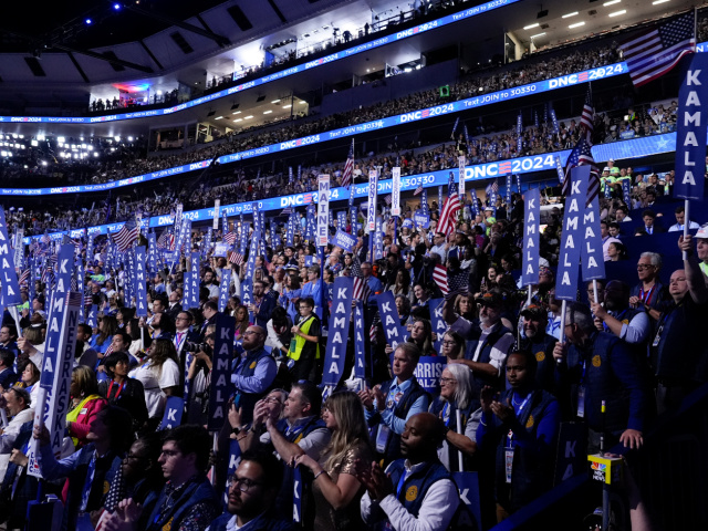 Delegates listen as Democratic presidential nominee Vice President Kamala Harris speaks on the final day of the Democratic National Convention, Thursday, Aug. 22, 2024, in Chicago. (AP Photo/Jacquelyn Martin)