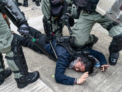 HONG KONG - AUGUST 24: A protester is detained by riot police during an anti-government ra