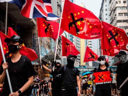 Thousands of people hold an unsanctioned protest march through the streets of Hong Kong on