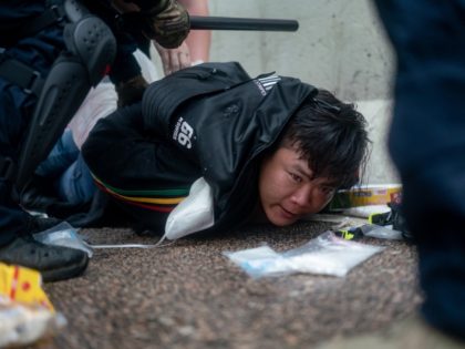 HONG KONG, HONG KONG - JUNE 12: A protester is arrested by police officer during a protest