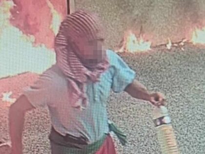 This CCTV image obtained by AFP on August 24, 2024 shows a potential suspect carrying two